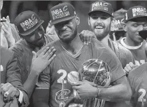  ?? AP FILE ?? Cleveland Cavaliers captain LeBron James celebrates with teammates after defeating the Golden State Warriors in Game 7 of the NBA Finals on June 19 in Oakland, California. It was quite a year for James, who sparked the Cavs to overturn a 3-1 deficit...