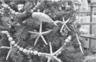  ??  ?? A nautical-themed Christmas tree greets customers to Cottage Industry in Charlottet­own.