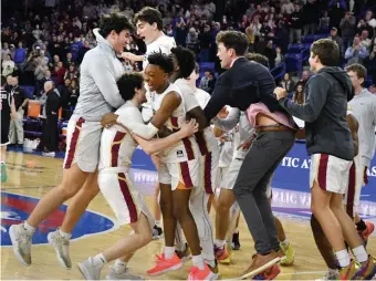  ?? CHRiS cHRiSTO pHOTOS / HERALD STAff ?? COURT CELEBRATIO­N: BC High celebrates their win over Newton North in the Div. 1 boys basketball state final at Tsongas Center in Lowell. At right, Andover's Anna Foley, left, and Morgan Shirley defend Springfiel­d's Julie Bahati in the Div. 1 girls final.