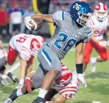  ??  ?? Lake Central’s Xavier Williams (26) tries to avoid a tackle by Crown Point’s Dominic Sopczak on Friday. KYLE TELECHAN / POST-TRIBUNE