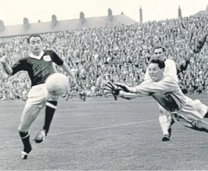  ??  ?? Alan Gilzean is foiled in his attempt to score for Dundee against United during a derby match at Tannadice in September 1962 and, right, representi­ng Scotland.
