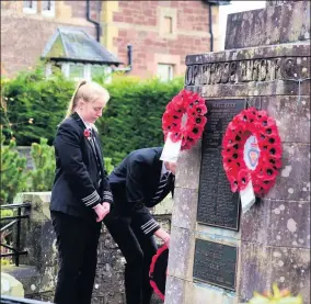  ??  ?? Poignant Head girl Jessica Murphy and head boy Rian Harvey lay a wreath on behalf of Crieff High School