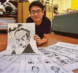  ?? AFP PIC ?? Singaporea­n cartoonist Sonny Liew posing with his work at his office in Singapore.