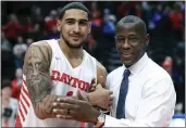  ?? AARON DOSTER — THE ASSOCIATED PRESS, FILE ?? Dayton’s Obi Toppin, left, celebrates scoring his 1,000th career point with head coach Anthony Grant after a game against Duquesne on Feb. 22in Dayton, Ohio. Toppin and Grant have claimed top honors from The Associated Press after leading the Flyers to a No. 3final ranking.