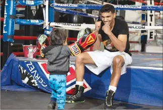  ??  ?? Borrero plays with his 20-month-old son, Joey Abraham Borrero, after a workout.