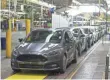  ?? SAUL LOEB, AFP/GETTY IMAGES ?? Ford Focus compacts are lined up at an assembly plant in Wayne, Mich.