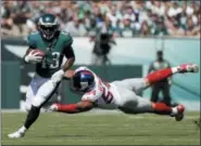  ?? MICHAEL PEREZ — THE ASSOCIATED PRESS ?? Eagles’ running back Darren Sproles, left, slips past the New York Giants’ Olivier Vernon during a game last season. Sproles returned to practice Wednesday after missing seven games with a hamstring injury.