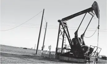  ?? SPENCER PLATT, GETTY IMAGES ?? An oil pumpjack works in Sweetwater, Texas. Since June 2014, prices for oil have fallen 70%.