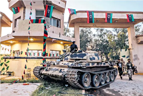  ??  ?? A Libyan National Army (LNA) tank in Al-aziziyah, located some 40km south of the capital, Tripoli. The LNA backs a Libyan opposition group seeking to overthrow the internatio­nally recognised government of Fayez al-sarraj
