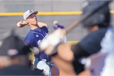  ?? GREG SORBER/ JOURNAL ?? Manzano junior lefty Mitchell Parker delivers an earlyinnin­g pitch to a Volcano Vista batter on Monday. The Hawks routed the Monarchs, 11-1.