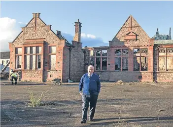  ?? Pictures: Paul Reid. ?? Councillor Colin Brown surveys the scene of devastatio­n at the former Wellbrae Primary School.