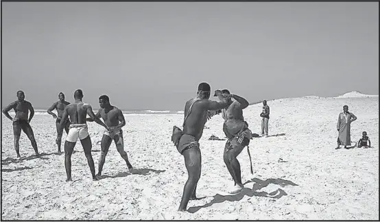  ?? [ Foto: Al Jazeera ] ?? Schönheit, Härte, Brutalität, diese drei. Wrestling am Strand von Dakar: traditione­ller senegalesi­scher Sport.