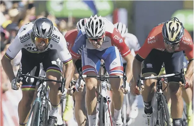  ?? PICTURE: MARCO BERTORELLO/AFP/GETTY ?? 0 Peter Sagan, left, holds on to win stage two of the Tour de France ahead of Sonny Colbrelli, far right, and Arnaud Demare, centre.