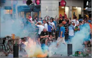  ??  ?? A teargas grenade explodes near an England fan ahead of England’s EURO 2016 match in Marseille. I could think of nothing worse than being in France for the tournament right