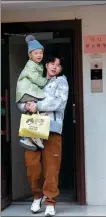  ?? Father in Charge. PROVIDED TO CHINA DAILY ?? Holding his son, sailor Zhao Zhiyuan, who used to spend most of his time at sea, takes on the role of a full-time dad in the reality show,