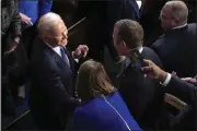  ?? PATRICK SEMANSKY — THE ASSOCIATED PRESS ?? President Joe Biden greets people as he arrives in the House chamber at the U.S. Capitol in Washington on Tuesday to deliver the State of the Union address to a joint session of Congress.