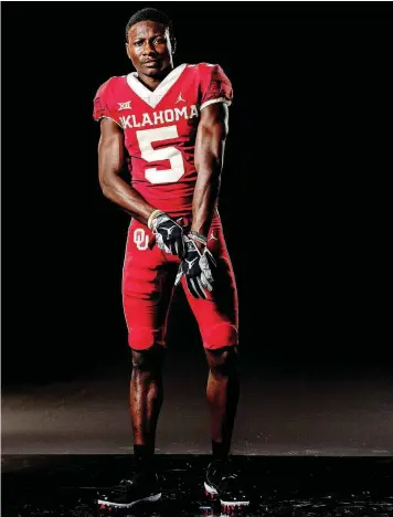  ?? [COURTESY OU ATHLETICS] ?? Wide receiver Marquise Brown shows off the crimson alternate uniform from Jordan Brand.