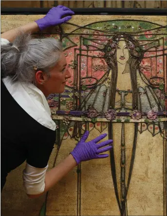  ??  ?? „ Stephanie de Roemer, a conservato­r with Glasgow Museums, with the central section of The May Queen.