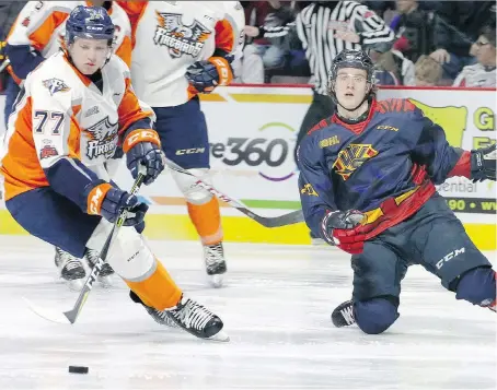  ?? NICK BRANCACCIO ?? Spitfires’ Cedric Schiemenz, right, draws a minor penalty as Flint Firebirds’ Jack Wismer plays the puck during Sunday afternoon’s OHL game at the WFCU Centre. The Spitfires got the game’s only goal early from Cole Purboo and then hung on to win 1-0.