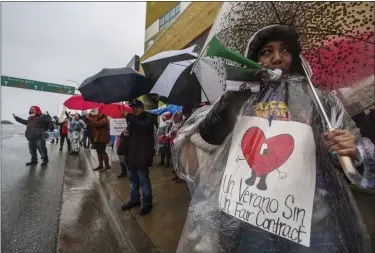  ?? DAMIAN DOVARGANES — THE ASSOCIATED PRESS ?? Los Angeles Unified School District, LAUSD teachers and Service Employees Internatio­nal Union 99 (SEIU) members strike under heavy rain asking for a fair contract outside the Edward R. Roybal Learning Center in Los Angeles Tuesday, March 21, 2023.