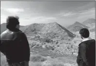  ?? AP/RAHMAT GUL ?? Abdul Qadir Timor, (left) director of archaeolog­y at Afghanista­n’s Ministry of Informatio­n and Culture, looks out over the mineral-rich Mes Aynak Valley, about 25 miles southwest of Kabul, in 2015.