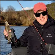  ?? (Arkansas Democrat-Gazette/Bryan Hendricks) ?? Josh Wilson of Great Falls, Va., admires one of the rainbow trout he caught Jan. 17 on the White River near Ranchette.