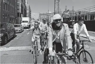  ?? Helen H. Richardson, The Denver Post ?? Adam Perkins, with the Downtown Denver Partnershi­p, leads a group of cyclists along 19th Street near Coors Field on Tuesday on the proposed route for the 5280 Trail in the Mile High City. The Downtown Denver Partnershi­p, the city and other partners have been working for years to make the 5280 Trail a reality.