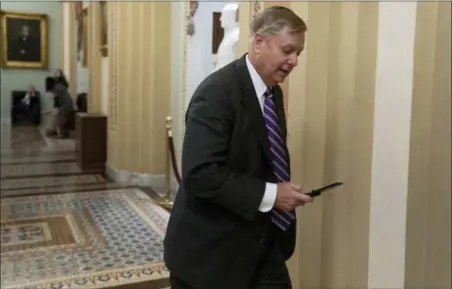  ?? J. SCOTT APPLEWHITE — THE ASSOCIATED PRESS ?? Sen. Lindsey Graham, R-S.C., a member of the Senate Armed Services Committee, rushes to the office of Senate Majority Leader Mitch McConnell, R-Ky., at day’s end Wednesday on Capitol Hill in Washington. Amid the news that President Donald Trump is pulling all 2,000 U.S. troops out of Syria, Graham said he was “blindsided” by the report and called the decision “a disaster in the making.”