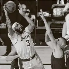  ?? Mike Ehrmann / Getty Images ?? Power forward Anthony Davis scored 37 points and grabbed 10 rebounds as the Lakers rolled over the Nuggets in Game 1.