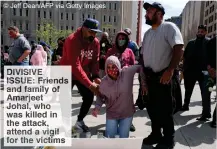  ?? © Jeff Dean/AFP via Getty Images ?? DIVISIVE ISSUE: Friends and family of Amarjeet Johal, who was killed in the attack, attend a vigil for the victims