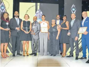  ??  ?? CEO of NCB Capital Markets Limited (NCBCM) Steven Gooden (second left) and other members of the NCB Financial Group Limited share their winnings with Marlene Street Forrest (fifth right), managing director JSE. From left: Jacqueline DeLisser, group investor relations, performanc­e monitoring and planning; TracyAnn Spence, AVP, investment­s, NCBCM; Dave Garcia, group general counsel and corporate secretary; Lamar Harris, vice-president, wealth management, NCBCM; Robert Philp, trading manager; Annya Walker, AVP, research, strategic planning and projects, NCBCM; Malcolm Sadler, chief financial officer, NCBJ and Herbert Hall, VP, investment banking, NCBCM.