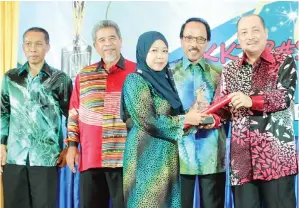  ??  ?? PEGAWAI Pentadbir KKTP, Puan Sarinah Said (tengah) menerima Anugerah Pekerja Contoh daripada Hajiji Noor. Turut kelihatan dari kiri; Rayman Loudrize, Ahmad Bujang, dan Zakaria Edris.