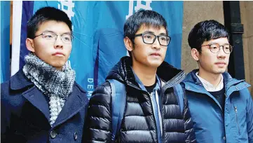  ??  ?? (From left) Wong, Chow and Law pose outside the Court of Final Appeal before a verdict on their appeal in Hong Kong, China. — Reuters photo