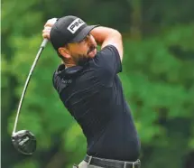  ?? AP PHOTO/CHARLIE NEIBERGALL ?? Chattanoog­a’s Stephan Jaeger hits off the second tee at TPC Deere Run on Friday. The former Baylor School and UTC standout shot a 70 and made the cut on the number.