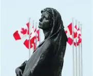  ?? SEAN KILPATRICK / THE CANADIAN PRESS ?? The statue of Veritas stands in front of the Supreme Court, which Friday struck down a law that forces those convicted of crimes to pay surcharges that help victims.