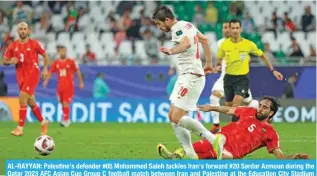  ?? – AFP ?? AL-RAYYAN: Palestine’s defender #05 Mohammed Saleh tackles Iran’s forward #20 Sardar Azmoun during the Qatar 2023 AFC Asian Cup Group C football match between Iran and Palestine at the Education City Stadium in Al-Rayyan.