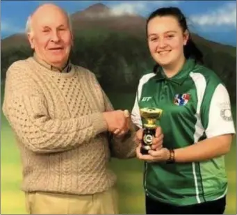  ??  ?? Jimmy Flood presents the National Junior Singles prize to Greenhills player Megan Devin, who defeated her clubmate Sophie Thornberry in the final at Lordship.