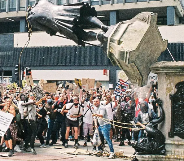  ?? ?? Mob rule: A crowd pull down the statue of slave trader Edward Colston in Bristol in 2020