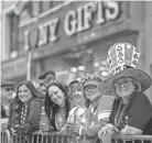  ?? IMAGES ANGELA WEISS/AFP VIA GETTY ?? Spectators look on during the St. Patrick’s Day parade in New York City on Friday.