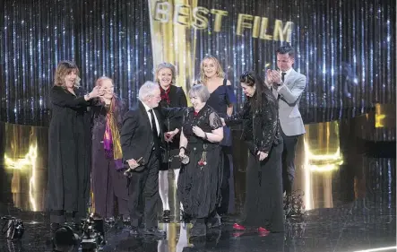  ?? CHRIS YOUNG/THE CANADIAN PRESS ?? Maudie director Aisling Walsh, centre, makes her way to the microphone.