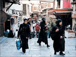  ?? HASSAN AMMAR/AP ?? Syrians walk Sunday in a market in the Old City of Damascus. Some in the Trump administra­tion painted last week’s strike as a possible portent of greater U.S. involvemen­t in Syria.