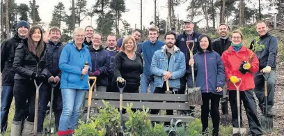  ??  ?? Digging in
Volunteers from West Lothian firm Calnex Solutions planted more than 300 native trees
