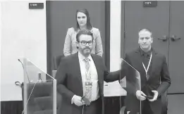  ?? COURT TV ?? In an image from video, defense attorney Eric Nelson, left, former police Officer Derek Chauvin and defense assistant Amy Voss introduce themselves to potential jurors last week in Minneapoli­s. Chauvin is charged in the death of George Floyd.