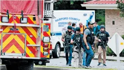  ?? MATT BUTTON/BALTIMORE SUN ?? A group of ATF police make their way to the shooting scene in northeaste­rn Maryland.