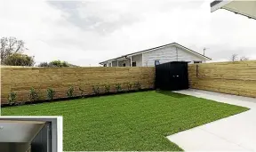  ?? ?? Out the back of the house is a fenced lawn and garden area complete with a shed, and folding washing line.