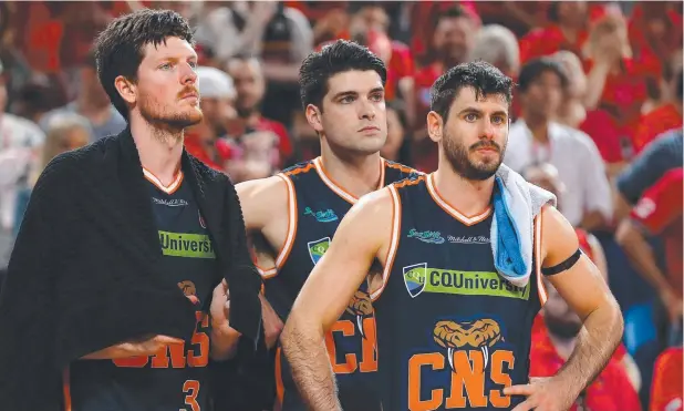  ?? Picture: GETTY IMAGES ?? FIGHTERS TO END: Cameron Gliddon, Stephen Weigh and Jarrad Weeks of the Taipans look on in the final minutes of Sunday’s loss to the Wildcats.