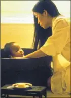  ?? Moviestore / REX / Shuttersto­ck ?? PARENT-CHILD moments permeate the adaptation of Amy Tan’s novel, here with Yu Feihong as a young mother in China.