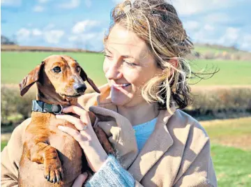  ??  ?? g Woman’s best friend: Kate MacDougall knows how to keep those pooches happy