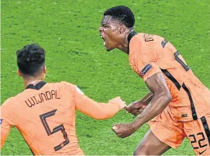  ?? OLAF KRAAK GETTY IMAGES ?? The Netherland­s roared to a 3-2 victory over Ukraine at Euro 2020 on Sunday with three goals after the opening half — with Denzel Dumfries, right, burying the winner in Amsterdam.