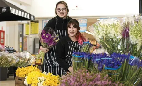  ?? PHOTO: KEVIN FARMER ?? FLORAL DISPLAY: Flowers 63 project manager Pat Ekkasame (left) and employee Kanokwan Janetummap­orn with the flower market-style retail outlet in High Street Shopping Centre.
Flowers 63 is located in the High Street Shopping Centre at Rangeville.